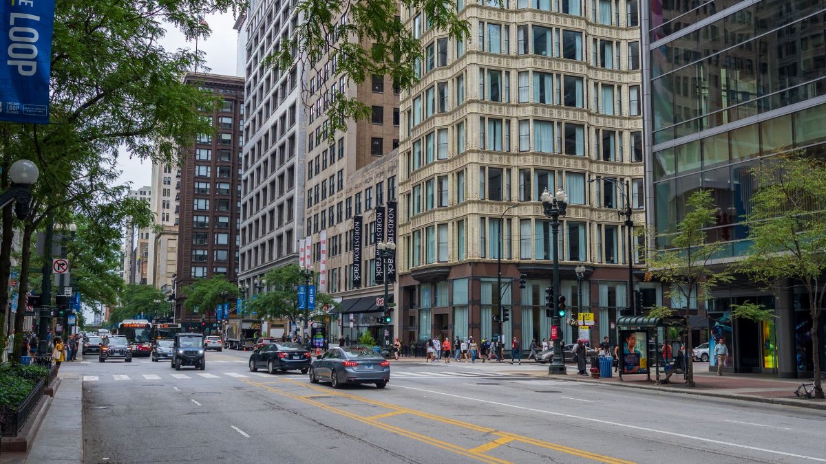 Downtown Chicago street scene with cars, people, and historic architecture in the Loop.