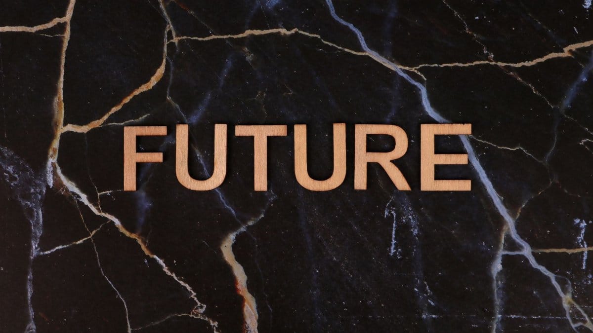 The word 'FUTURE' on a dark marble background evokes forward-thinking concepts.
