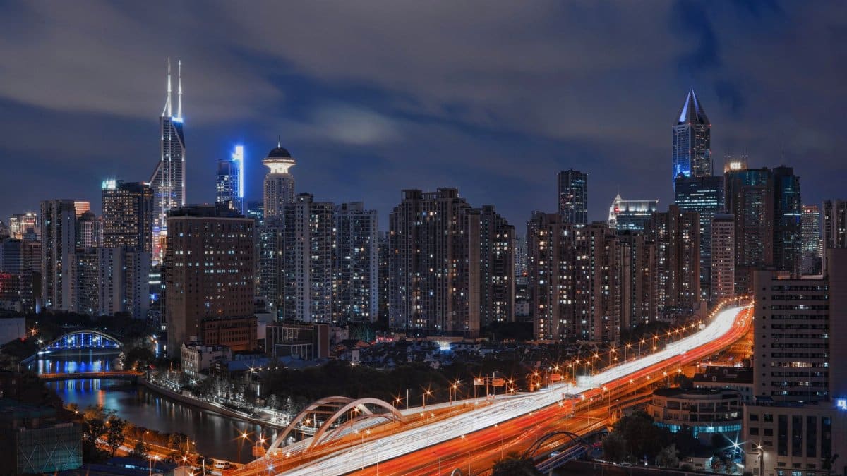 Stunning long exposure shot of a city skyline illuminated at night with vibrant skyscrapers.