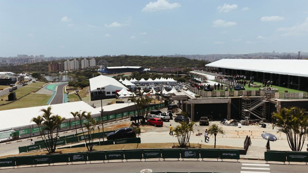 A bustling scene at Interlagos Circuit, showcasing racing event activities under sunny skies.