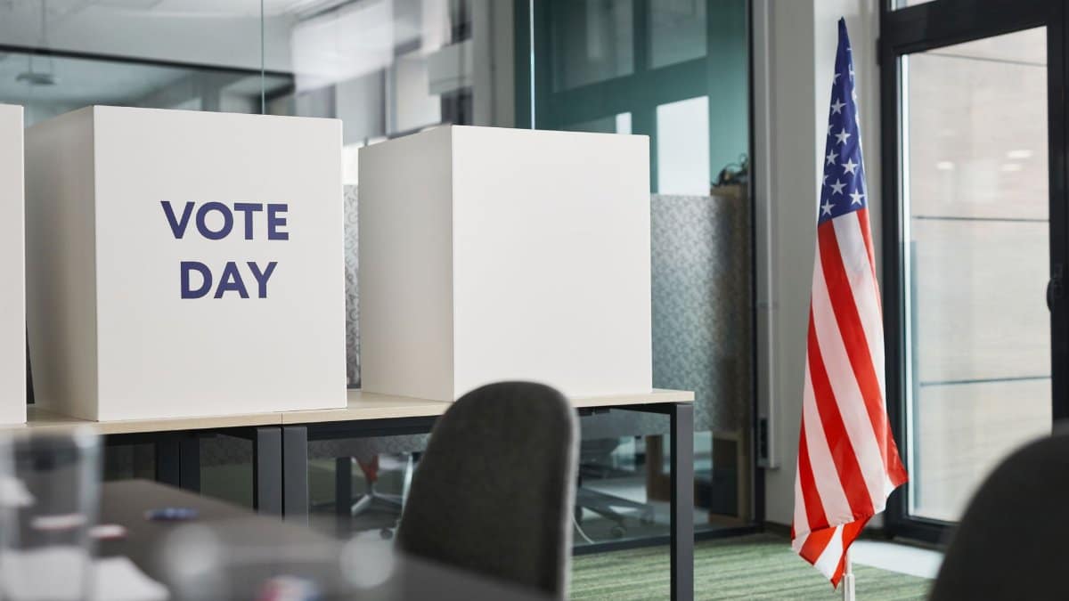 Voting booths with an American flag in an office, symbolizing Election Day.