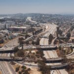 Aerial view of complex highway intersections in Los Angeles showcasing city infrastructure and urban landscape.