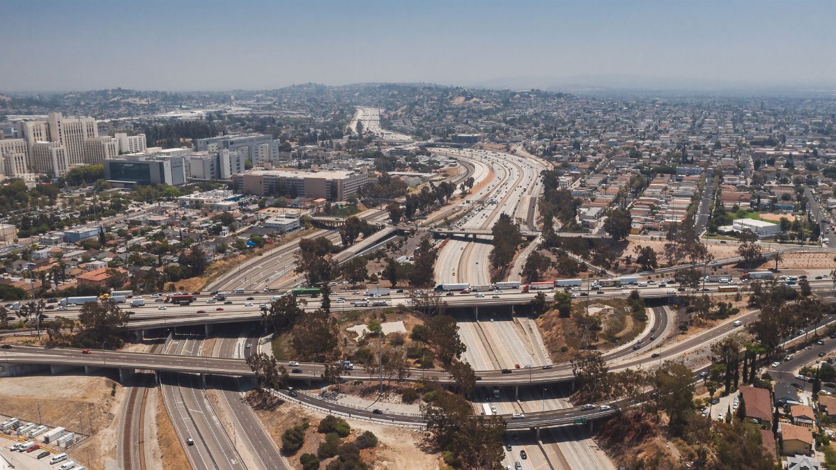Aerial view of complex highway intersections in Los Angeles showcasing city infrastructure and urban landscape.
