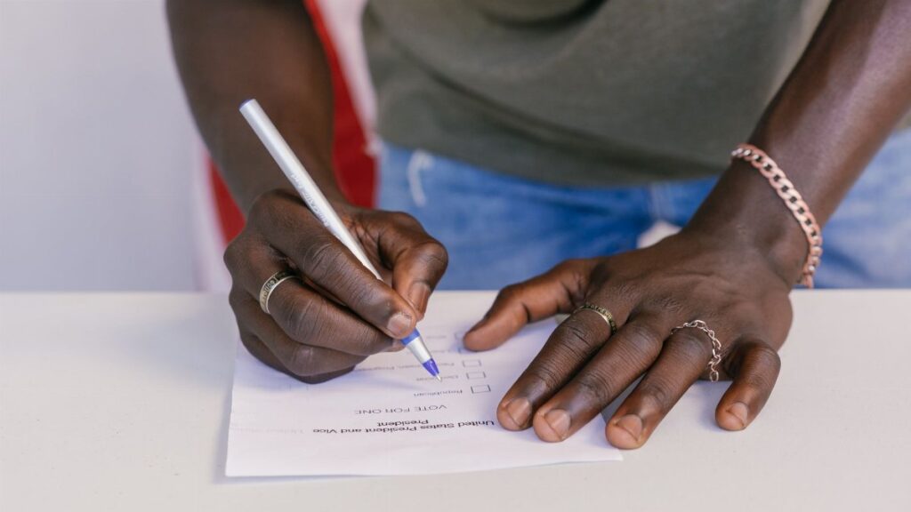 A close-up of a person marking a ballot paper during an election.
