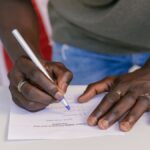 A close-up of a person marking a ballot paper during an election.
