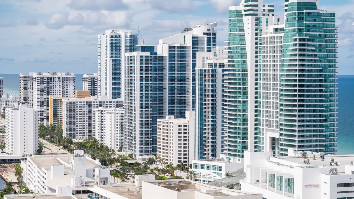 Aerial view of Hollywood, Florida's modern skyline along the coast with high-rise buildings and ocean views.