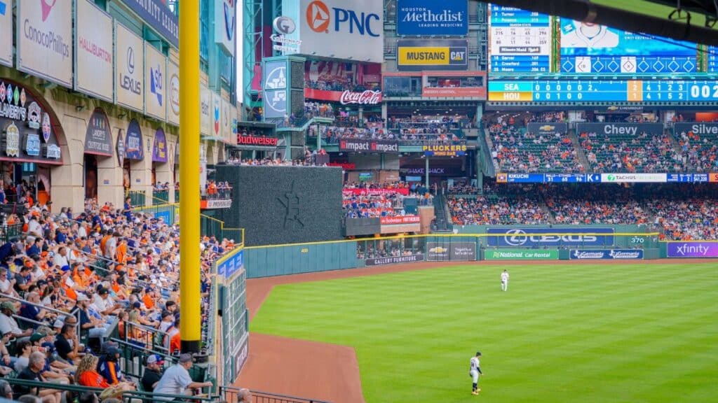 Vibrant baseball game scene with a full stadium, cheering crowd, and bright advertisements.