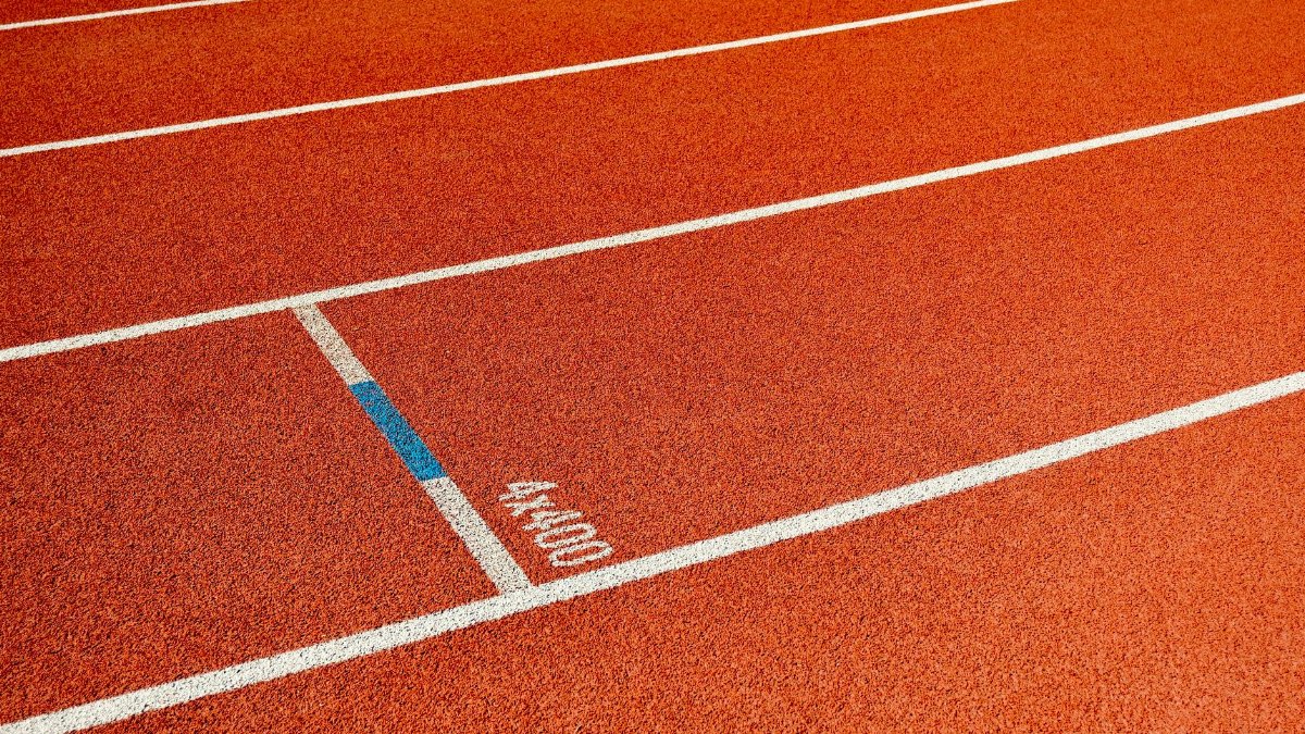 Detailed view of empty athletic track lanes, ideal for sports themes.