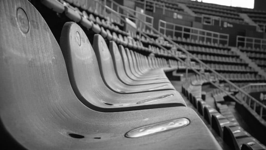 Close-up view of empty stadium seats in black and white capturing a dramatic perspective.