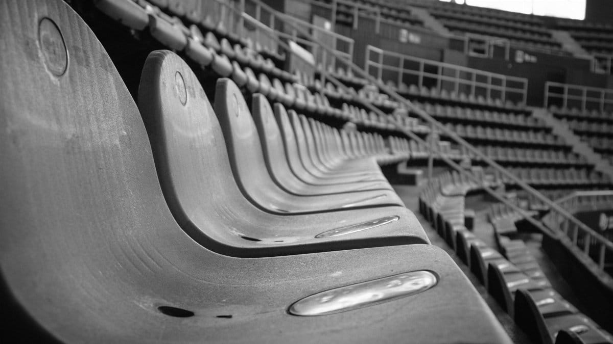 Close-up view of empty stadium seats in black and white capturing a dramatic perspective.
