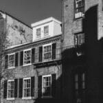 Black and white photo of historic brick buildings in Beacon Hill, Boston, capturing architectural details.