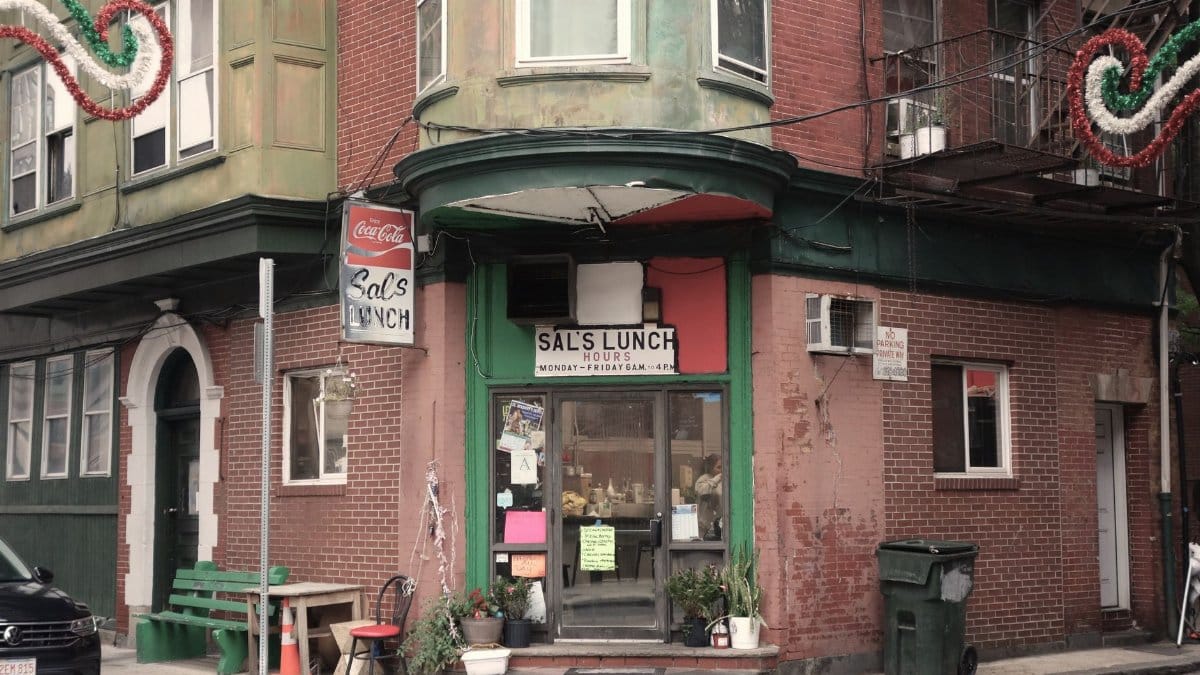A vintage diner facade on a street corner in Boston's historic North End.