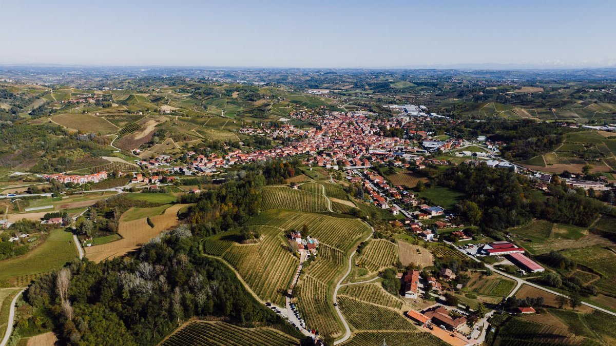 A stunning aerial view of Canale, Piedmont, highlighting its vineyards and rolling hills.