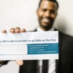 African American man holding envelope emphasizing credit card debt relief options.