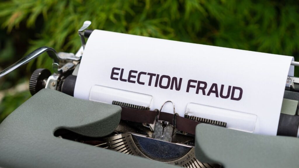 A close-up of a vintage typewriter with a paper displaying 'Election Fraud'. Ideal for themes of politics and nostalgia.