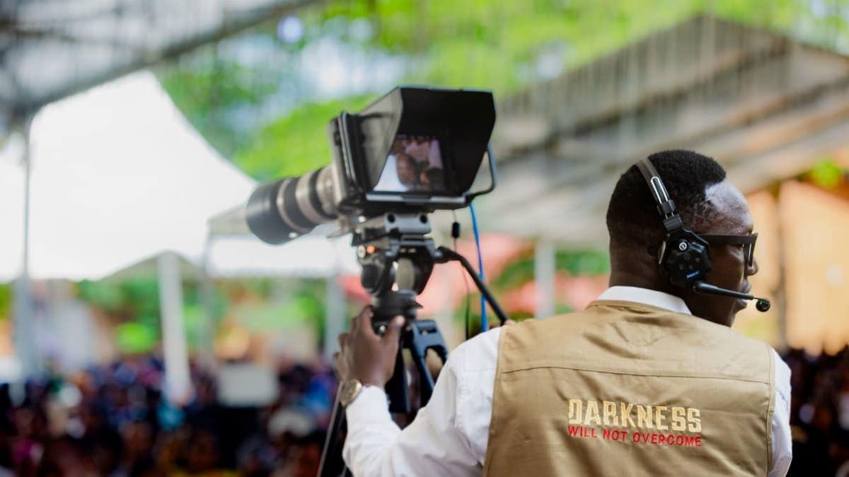 Cameraman captures a live event in Dar es Salaam, Tanzania, showcasing local media production.