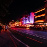 Explore the vibrant nightlife with neon lights and crowded streets on Miami's famous Ocean Drive.