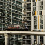 A Miami monorail travels past modern high-rise apartments in downtown Miami, Florida.