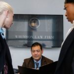 Diverse colleagues gathering in conference hall of law firm and discussing details of contract while working together