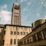 Aerial view of a historic clock tower in a sunny Minneapolis courtyard.