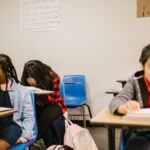 Three students in a classroom, focusing on bullying prevention awareness.