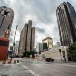 Explore the modern skyline of downtown Dallas, Texas with towering skyscrapers under a dramatic sky.