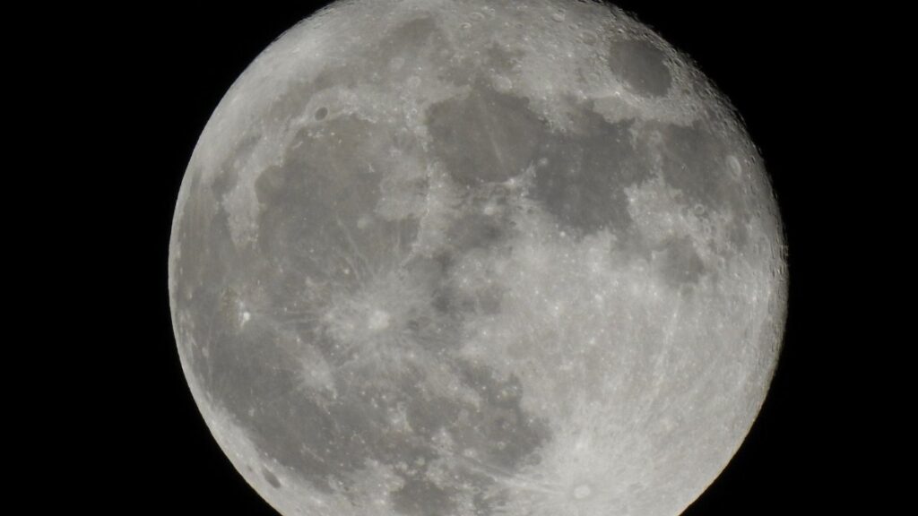 Captivating view of the full moon with clear lunar craters and details.