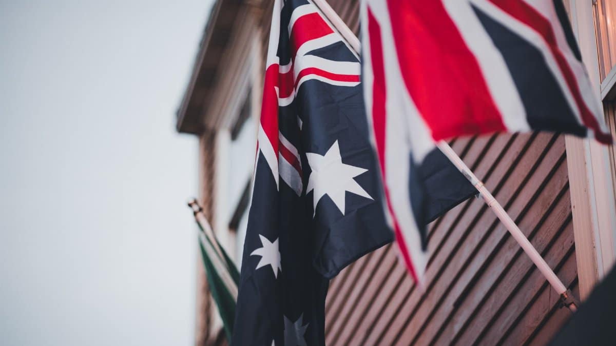 Close-up of Australian and British flags on a building's wooden exterior, signifying national pride.