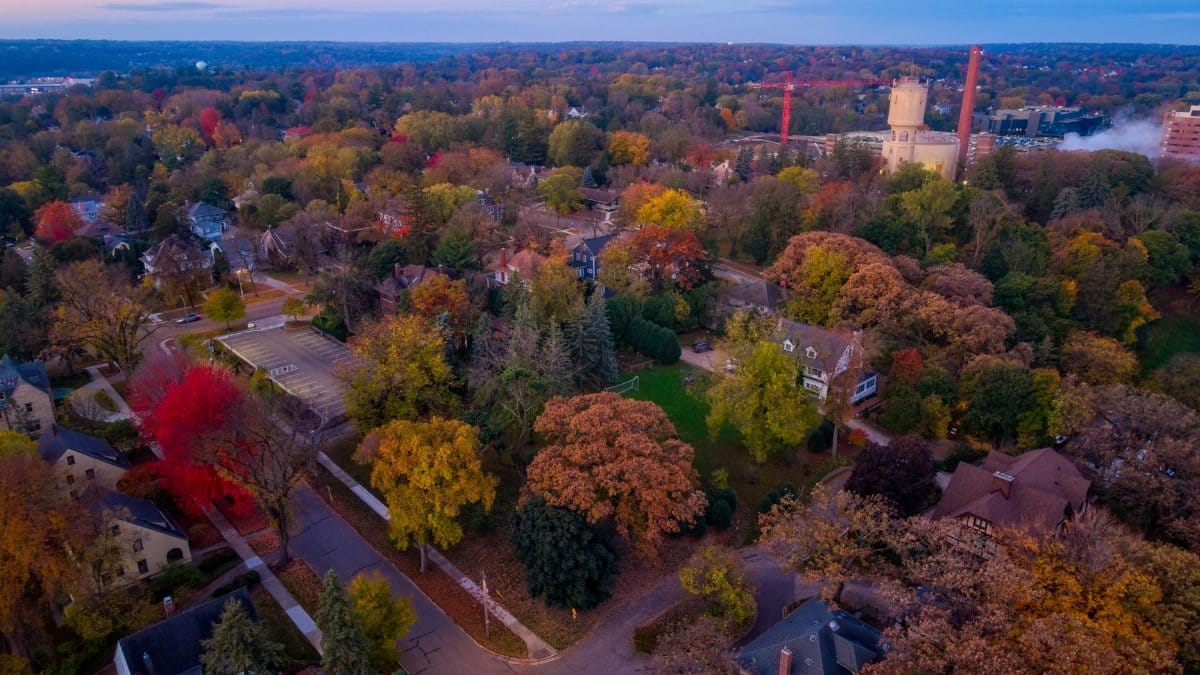 A stunning aerial view of Rochester, Minnesota, showcasing vibrant fall foliage in a residential area.