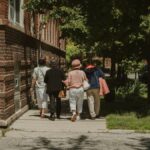 A diverse group of women walking together on a sunny day in a Chicago neighborhood street.