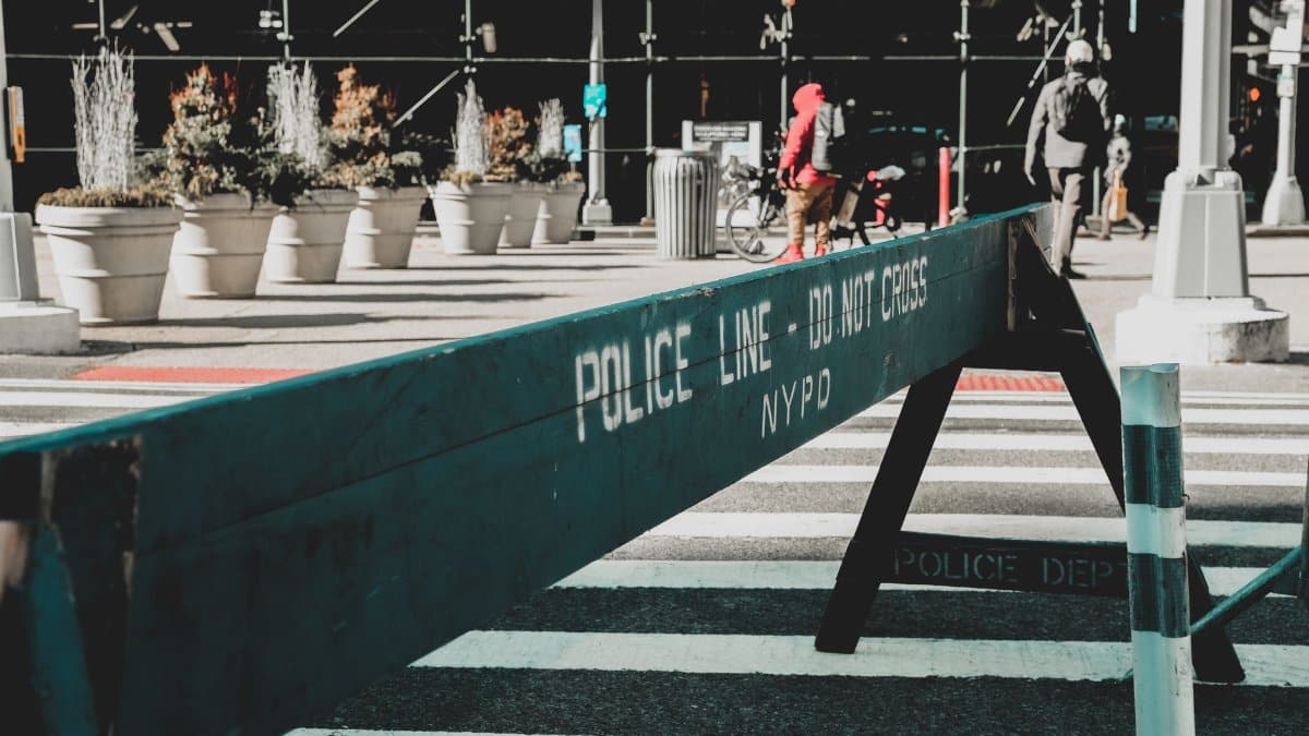 Close-up of NYPD police barrier in city street setting highlighting urban safety measures.