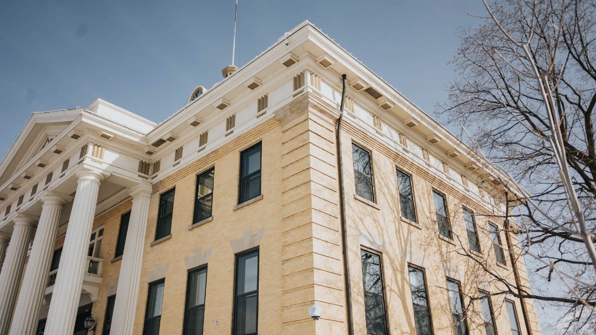 Low angle view of the historic Box Elder County Courthouse with columns and blue sky, Brigham City, Utah.