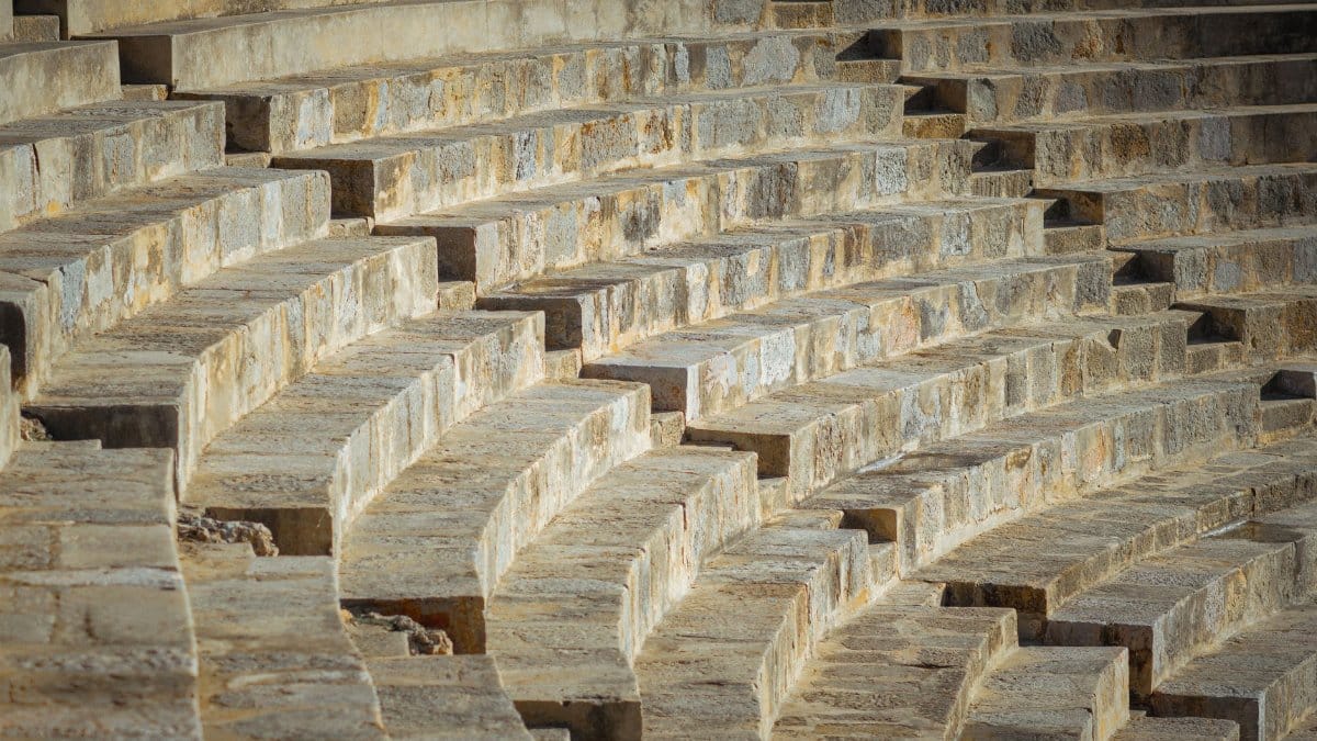 Close-up of ancient Roman amphitheater steps in Uthina, Tunisia's historical site.
