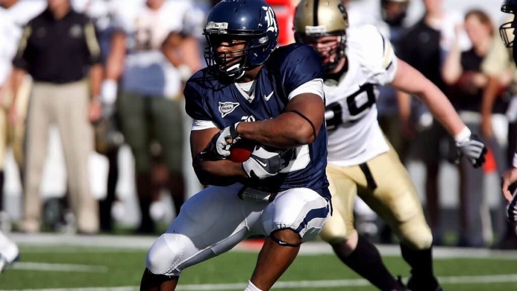 Intense moment captured during an American football game showcasing players in full action on the field.