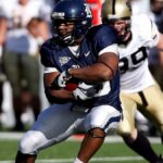 Intense moment captured during an American football game showcasing players in full action on the field.