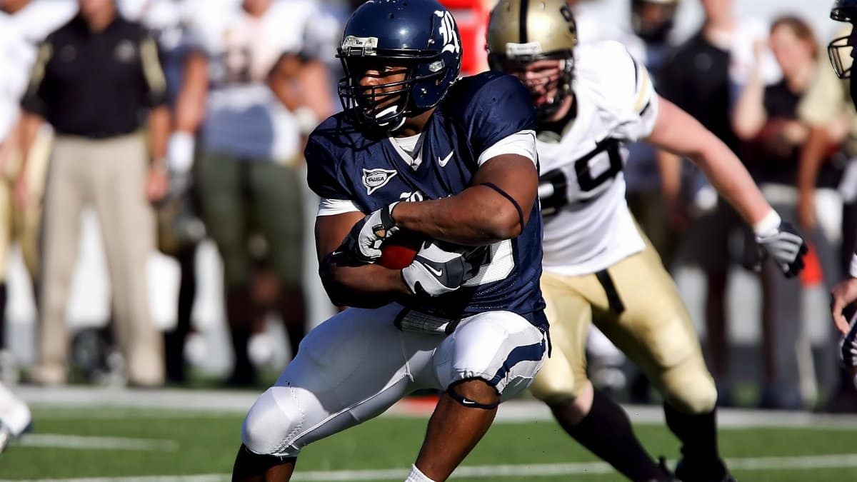 Intense moment captured during an American football game showcasing players in full action on the field.