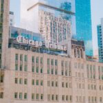 A view of the iconic Chicago Tribune Tower amidst modern skyscrapers in downtown Chicago.