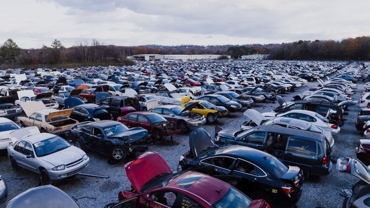Wide view of a large car junkyard in Chattanooga with numerous vehicles showing signs of wear.
