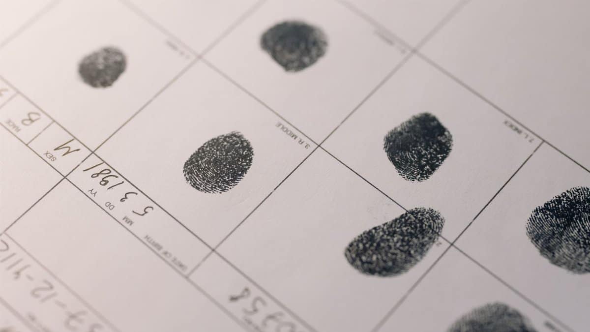 Detailed fingerprints on official document, highlighting identity verification process.