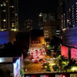 Night view of bustling Brickell with city lights, traffic, and skyscrapers.