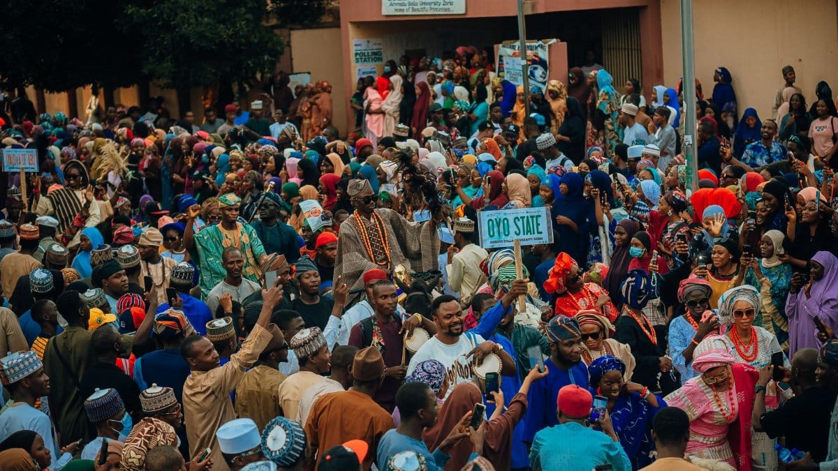 Vibrant cultural festival outdoors with diverse crowd in Nigeria.