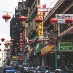 Bustling San Francisco Chinatown street with red lanterns and shops, capturing urban vibrancy.
