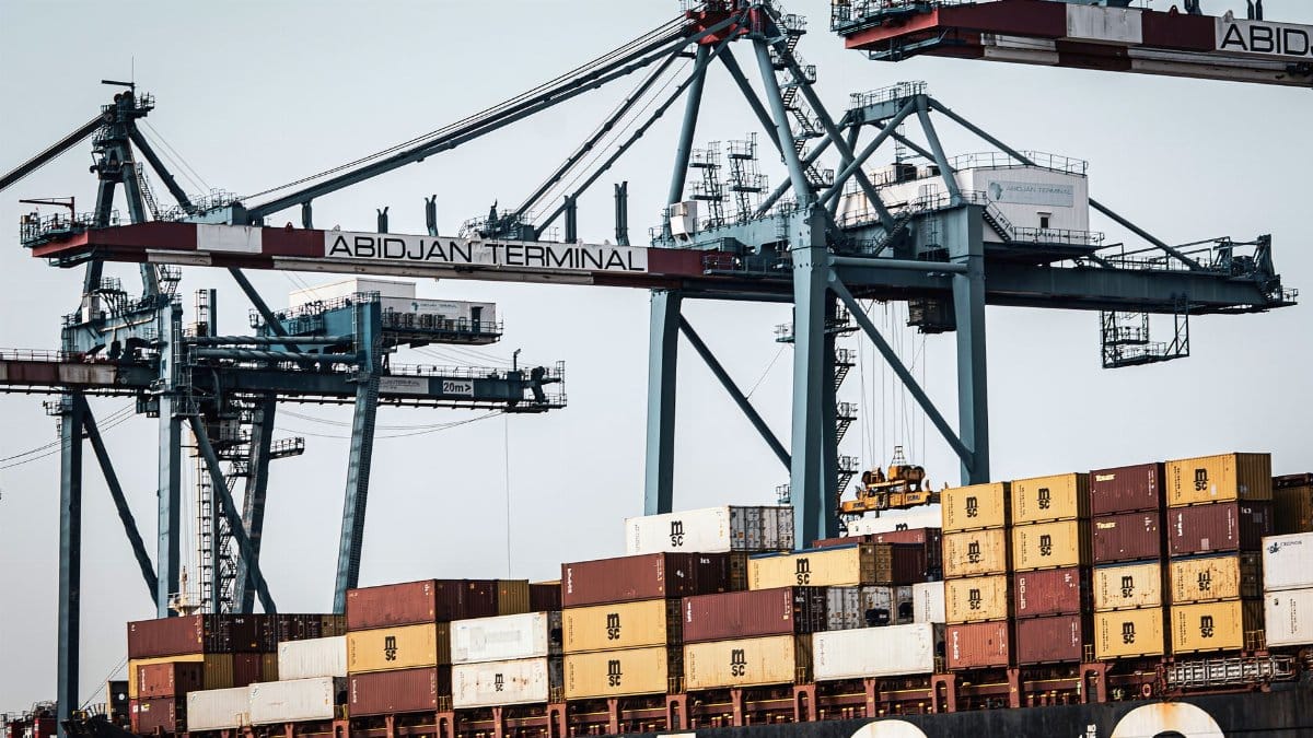 A view of large cranes and cargo containers at the busy Abidjan Terminal port.
