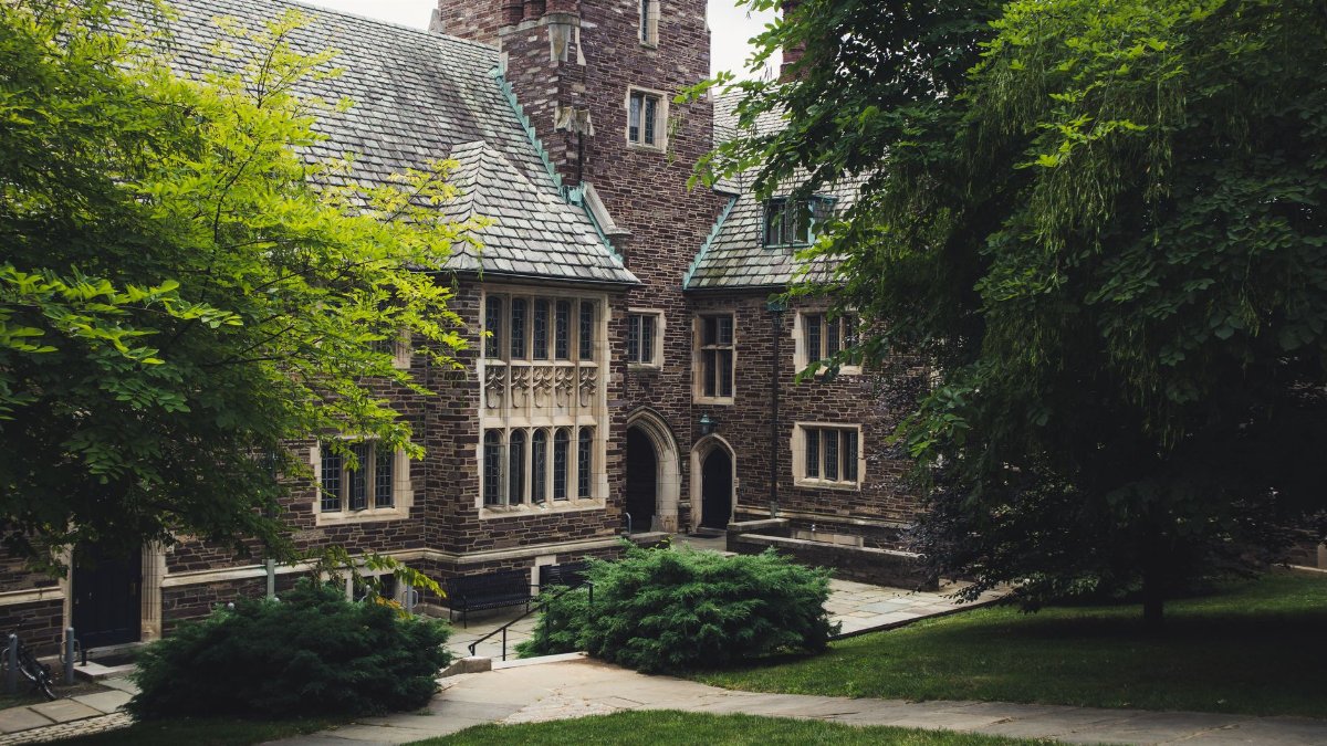 Elegant Gothic architecture of Princeton University surrounded by lush greenery on a summer day.