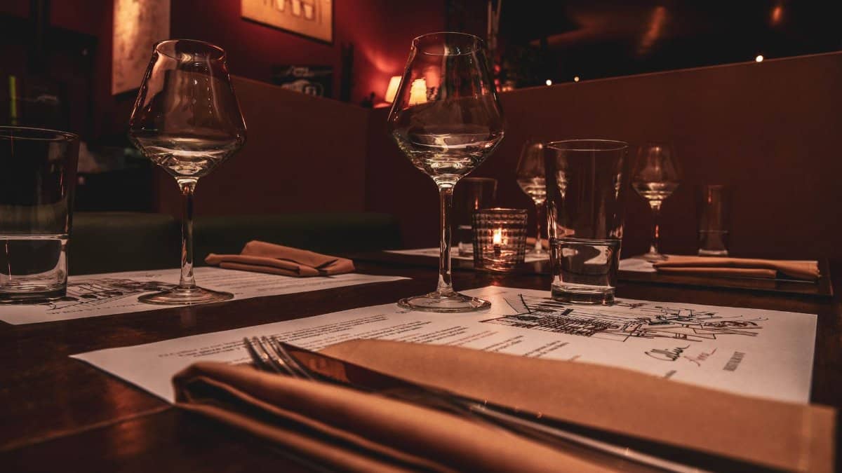 Romantic restaurant setting with candlelight and elegant tableware, perfect for fine dining ambience.
