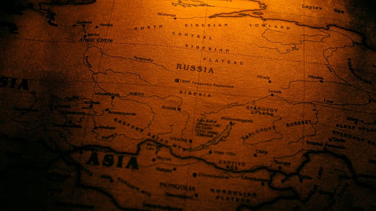 Close-up of an antiqued map highlighting Russia in a warm sepia tone.