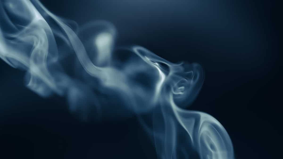 Intriguing capture of swirling smoke against a dark background, creating a mysterious and ethereal atmosphere.