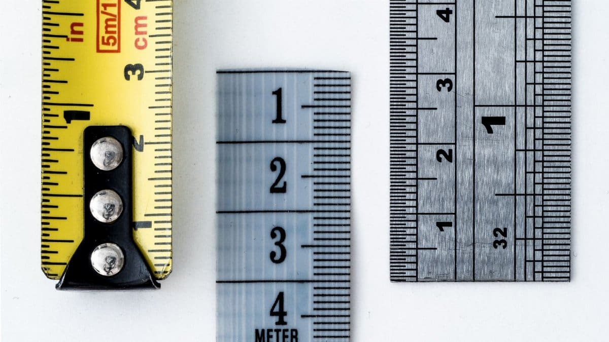 High-resolution image of a tape measure and rulers, showing precise millimeter, centimeter, and inch markings.