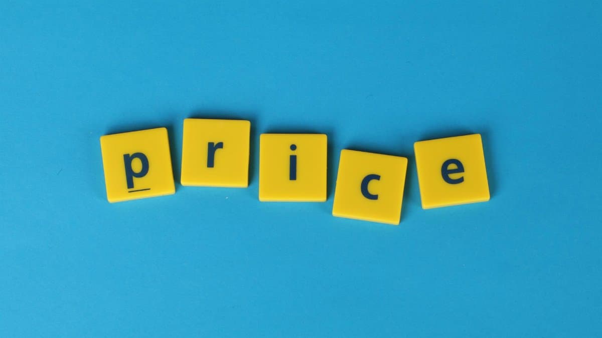 Yellow letter tiles spell the word 'price' against a vibrant blue backdrop, ideal for business concepts.