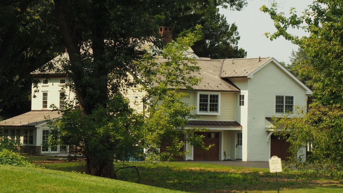 A serene suburban home nestled among trees, showcasing traditional architecture in Pennsylvania.